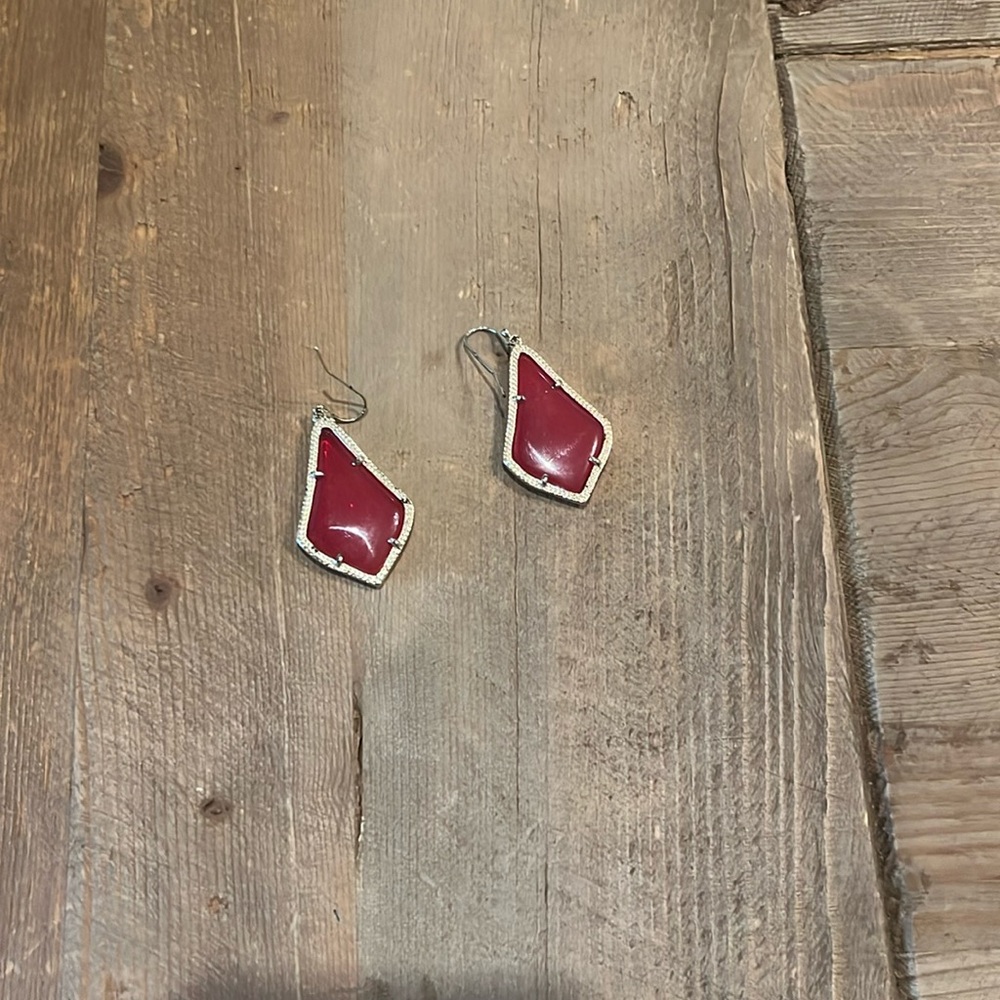 Kendra Scott red drop earrings with gold trim.